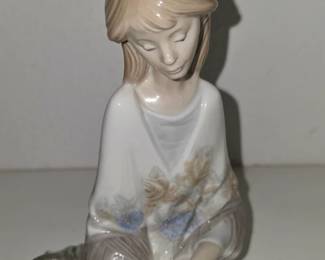 Lladró-style porcelain girl with flowers/basket, likely Lladró or NAO by Lladró