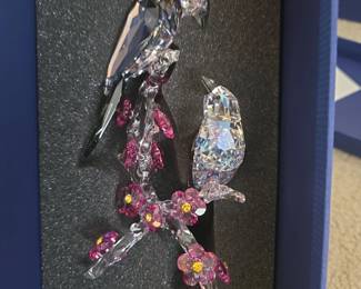 This Swarovski Tutelary Spirit figurine features two magpies in Crystal Moonlight and Black Diamond crystal on a cherry blossom branch.