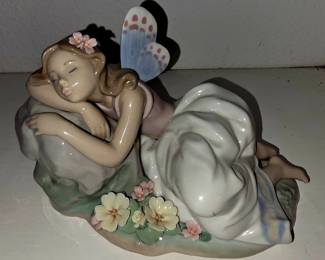 This is Lladró “A Moment’s Rest” #6173, the reclining fairy with butterfly wings and flowers.