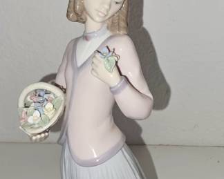 Lladró / NAO-style porcelain girl holding a basket of flowers,