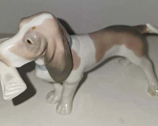 Lladró-porcelain dog holding a newspaper.
