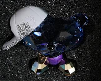 This is a Swarovski Lovlots Bo Bear figurine, specifically the "Hip-hop Bo" (model 1186631), identifiable by its violet body and lavender crystal head.