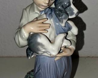 Lladró “Boy with Dog” #4522, also seen as “Shhh / Quiet Puppy” style. It’s a retired Lladró piece, about 7.5" tall, made roughly 1970–1997. �