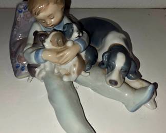 Lladró “This One’s Mine” #5376, also described as boy with dog and puppies. It’s a larger retired Lladró piece, around 7" tall x 9" wide, issued in the mid-1980s and retired in the mid-1990s.