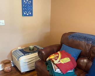 Leather sofa, ottoman, artwork, linens
