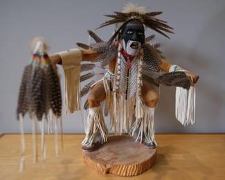 Hand-crafted by Navajo artisan C. Jim, this mixed-media Plains Dancer figure features traditional feather and leather work set on a rustic wood base.