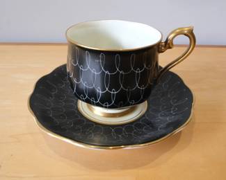 This is a vintage Royal Albert teacup and saucer in the black "Swirl" pattern from the 1930s-1940s.Manufacturer: Royal AlbertSeries: Un-named "Swirl" series, commonly featuring Art Deco style shapesColor & Design: Black glaze with a delicate white swirl or loop pattern and gold trimEra: Produced approximately between the 1930s and 1950s.