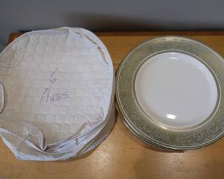 This set is Royal Doulton English Renaissance plates featuring a green scroll pattern with gold trim.Produced from 1963 to 1996, the pattern is made from fine bone china and crafted in England. 12 bowls, 5 bread/salad plates, 6 dinner plates, and 4 bread & 4 tea plates.