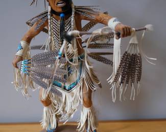 Hand-crafted by Navajo artisan Sal Nez, this mixed-media Plains Dancer figure features traditional feather and leather work set on a rustic wood base.