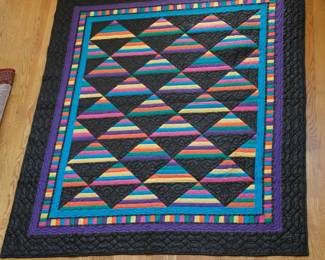 The quilt shown is a beautiful variation of the traditional Amish Roman Stripe pattern. The 76" x 92" dimensions make it an ideal size for a Twin bed with a generous drop, or it can serve as a substantial top-of-bed coverlet for a Full/Queen size bed.
