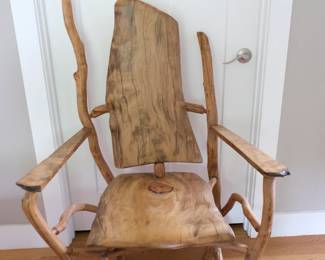 This rustic primitive throne chair is handcrafted from raw tree limbs and branches.