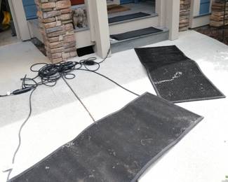 These items are heated snow melting mats designed to prevent ice buildup on walkways.They feature a non-slip rubber surface for safety during winter conditions.The mats require a 120V power cord to operate the heating elements.
