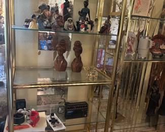 Glass and brass regency style shelves; figurines