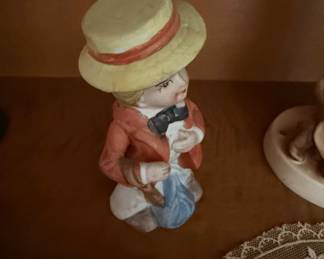 Porcelain Figurine of a Boy with a Camera and Blue Bundle