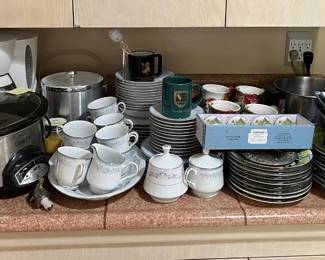 This sale is like most sales and includes a fair number of kitchen-related items: plates, cups, a coffee maker (back left), and the Crock Pot.