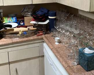 The picture here shows a large collection of glasses and similar stemware.  But don't forget the other side's rolling pin, knife block, and pressure cooker.