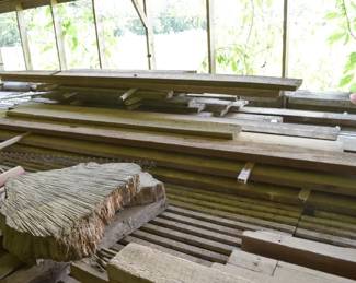 Stacked Rough-Cut Dimensional Lumber Boards with Natural Edge Wood Slabs