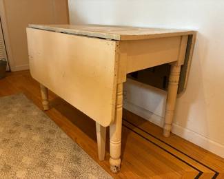 This is a vintage drop-leaf farmhouse table, painted. Surface needs love but the table is in terrific condition. Approximate scale opened is 6' x 4'.