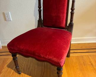 Gorgeous antique chair with deep red velveteen upholstery.