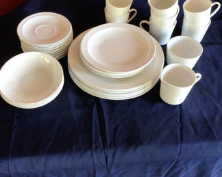Lot 18: White ceramic dinnerware set with plates, bowls, and mugs