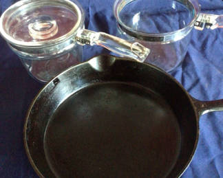 Lot 22: Cast iron skillet with two glass cookware pots