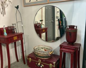 Asian red side tables, trunk, brass leaves on wall, fish bowl