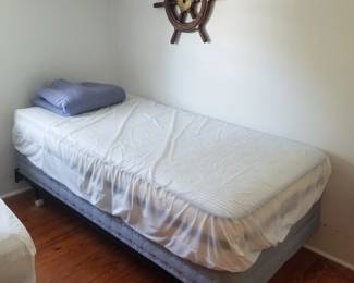 Twin bed; decorative ship's wheel
