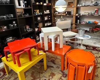 Mid-century modern plastic tables in white, red, yellow, and orange, including Giotto Stoppino for Kartell vintage orange stacking tables in ABS plastic, first produced in 1968