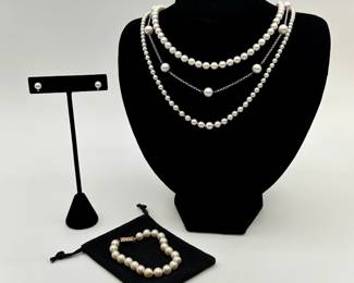 A 14k gold clasp 20" graduated pearl necklace with shortener, a 14k gold clasp 15" pearl necklace, a sterling silver and cultured pearl station necklace, a pair of cultured pearl and topaz stud earrings, and a 14K gold clasp pearl bracelet