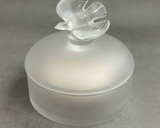 Closer view of the vintage Lalique crystal powder box created in France for Nina Ricci's "L'Air du Temps" fragrance. Circular frosted crystal box with dove finial on gently rounded lid.