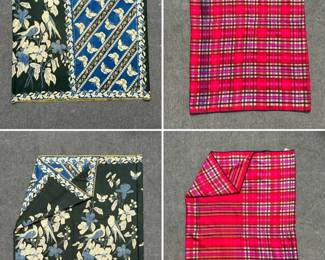 Two ceremonial Indonesian batik tulis prada sarong: One a featuring a Pekalongan-style design with birds, butterflies, and floral patterns in deep blue and green; the other in a complex geometric plaid or tartan pattern, primarily in vibrant shades of red and pink with cream and black