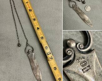 A Georg Jensen sterling silver dagger-form letter opener with a long chain ending in a small ball weight; stamped with Georg Jensen logo, STERLING DENMARK, and the numbers 254.