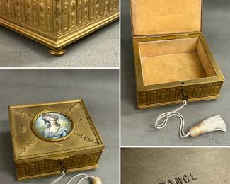 A fabulous 19th century French gilt bronze jewelry box, the lid top with miniature portrait medallion centered amidst ornate applied floral sprays on textured surface, the lid edge with laurel wreath band and box sides with vertical panels of acanthus leaves, the box on raised feet. Marked FRANCE on the base. With key on tasseled string as shown.