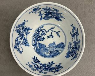 Another view of the Chinese porcelain enameled carp/fish bowl with rounded sides rising from a short foot to a slightly everted rim, the exterior vividly enameled in red, green, and black with carp swimming amidst water plants, the interior decorated in underglaze blue with a roundel scene of "San Yang" (three goats) in a landscape, the walls with floral branches and precious objects; Daoguang seal mark to the base.