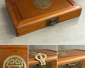 Vintage Chinese style wooden jewelry box with decorate brass hardware and engraved brass Chinese longevity symbol on the lid, padded red fabric compartmentalized interior.