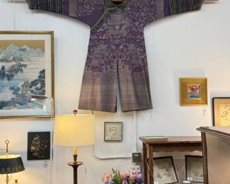 A stunning antique Chinese Qinq Dynasty silk kesi dragon purple robe with 9 total five-clawed dragons (one hidden by the over-flap); colorfully rendered Daoist and Buddhist symbols including flaming pearl, cranes, bats, twin golden fish, Wheel of Law, parasol, endless knot, others amidst clouds above rocks, waves, and lishui striped hem. Sleeve extensions w/ color stripes end in Manchu “horse hoof” cuffs decorated w/dragons. Orange, pink, yellow, red, purple, blue, and green. 