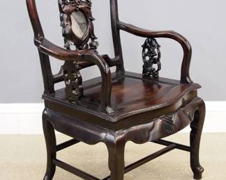 A turn of the century Chinese Scholar's armchair. Rosewood construction with carved detail features a shaped open back with center splat and inset marble medallion, shaped arms with carved supports, paneled seat and cabriole legs connected by turned stretchers. Refinished with some wear. 23 1/2 x 20 x 38 1/2" high overall. ESTIMATE $300-500