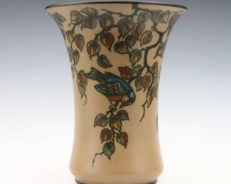 An early 20th century L. Hjorth Art Pottery vase. Flared form with multi-color songbird and fruit tree decoration on a matte Brown ground. Impressed "L. Hjorth" and "Denmark" marks. Slight wear. 10 1/2" high. ESTIMATE $300-400