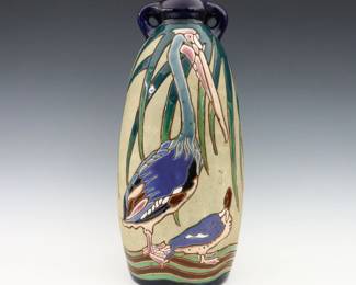 A late 19th century Amphora Art Pottery vase. Molded body with two handles and incised multi-color Pelican and Duck decoration. Printed "Amphora / Made in Czecho-Slovakia" and impressed marks. Minor surface wear and scuffs. 17 1/2" high. ESTIMATE $200-400