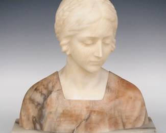 An Italian Art Nouveau Period Alabaster and Marble bust. Carved bust of a woman with braided crown hairstyle accented by a small bow. Incised "Made in Italy" on the back of the plinth. Light scratches overall with some flakes to plinth. 14 x 6 x 14 1/4" high overall. ESTIMATE $200-400