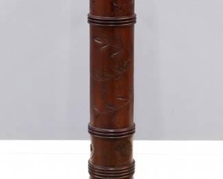 A Victorian Walnut Pedestal. Walnut construction with circular revolving top, column on a square plinth. Decorated with stylized flower, leaf, and vine motif. Some small nicks and losses, older finish with some wear. 14 3/8 x 14 3/8 x 39 1/2" high overall. ESTIMATE $200-400