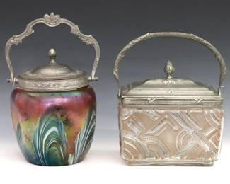Two turn of the century Bohemian Art Glass biscuit jars. Pinched and molded glass bodies in various colors with metal fittings, one with Iridescent pulled decoration and the other with Pink frosted decoration. Minor surface wear and fleabites, metal with oxidation. Up to 7 1/2" high. ESTIMATE $200-300