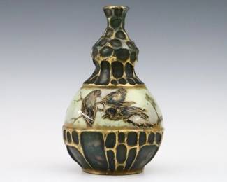 A late 19th century Amphora Art Pottery vase by Riessner, Stellmacher & Kessel. Molded bottle form body with multi-color Songbird decoration and Gilded detail. Printed "RStK / Turn Teplitz, Bohemia" and impressed "Amphora / Austria" marks. Minor wear. 7 3/4" high. ESTIMATE $200-300