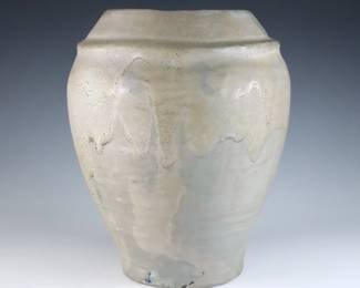 An early 20th century Pewabic Pottery vase. Tapered form with pinched shoulder and iridescent drip glaze in shades of Pale Green and Gold. Impressed circular "Pewabic Detroit" mark. Minor surface wear, 1/2" flake to foot. 7 3/4" high. ESTIMATE $600-800