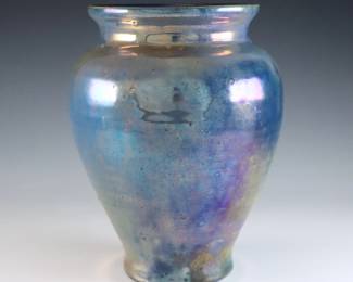 An early 20th century Pewabic Pottery vase. Baluster form with linear ribbed body and iridescent glaze in shades of Blue, Purple and Gold. Impressed circular "Pewabic Detroit" mark. Slight surface wear. 7" high. ESTIMATE $1,500-2,500