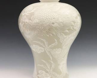 Korean Goryeo style porcelain Plum vase. Inverted baluster form Maebyeong vase with high shoulder and tapered waist, slip decoration with four toed Dragon and cloud motif and crackle glaze overall. Two character mark and red seal at the underside. Light wear. 11" diameter, 13 5/8" high. ESTIMATE $600-800