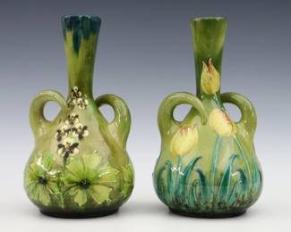 Two turn of the century Austrian Art Pottery vases. Molded bottle form bodies with two curved handles and multi-color floral decoration. Impressed "Austria" with painted marks. Minor wear, some crazing. Up to 10 3/4" high. ESTIMATE $200-300