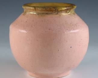 An early 20th century Pewabic Pottery vase. Bulbous form with iridescent glaze in shades of Pale Pink and Gold. Impressed circular "Pewabic Detroit" mark, retains partial medallion "Pewabic Detroit" paper label c. 1915-1930. Crazing, slight surface wear. 4" high. ESTIMATE $400-600