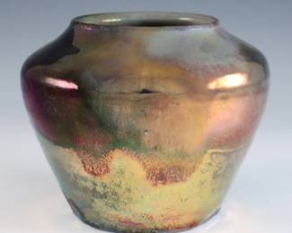 An early to mid 20th century Pewabic Pottery vase. Tapered form with high shoulder and iridescent glaze in shades of Pale Green, Oxblood and Gold. Impressed circular "Pewabic Detroit" mark. Slight crazing and surface wear. 4" diameter x 3 1/2" high overall. ESTIMATE $400-600