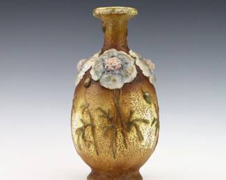 A late 19th century Amphora Art Pottery vase. Molded body with applied floral design and multi-color decoration with Gilded detail. Impressed "Amphora / Austria" with Crown marks. Minor wear. 11" high. ESTIMATE $200-300